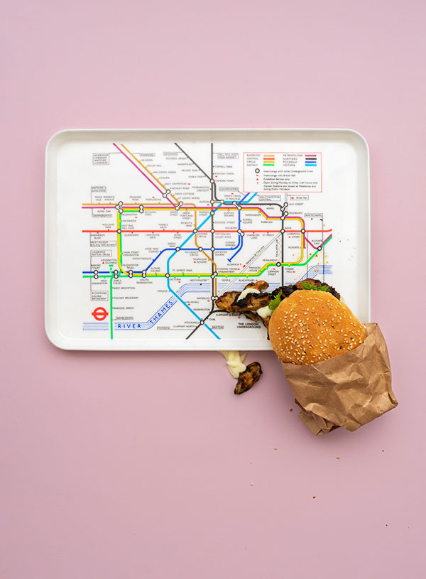 Een dienblad met de kaart van de Londense metro erop met erbij een broodje jrek paddenstoelen met mayonnaise en peterselie.